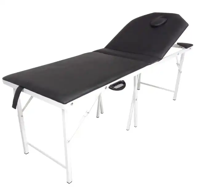 Folding massage table with black upholstery, white legs and a face cradle, available to rent in Medellín